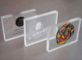 Three clear acrylic blocks with custom branding and logo samples
