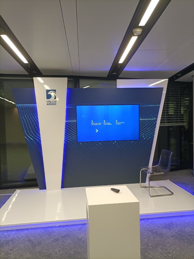 ADNOC exhibition kiosk with LED platform and acrylic chair