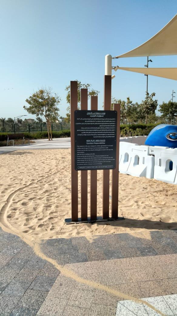 Beach area directional pylon sign in sand