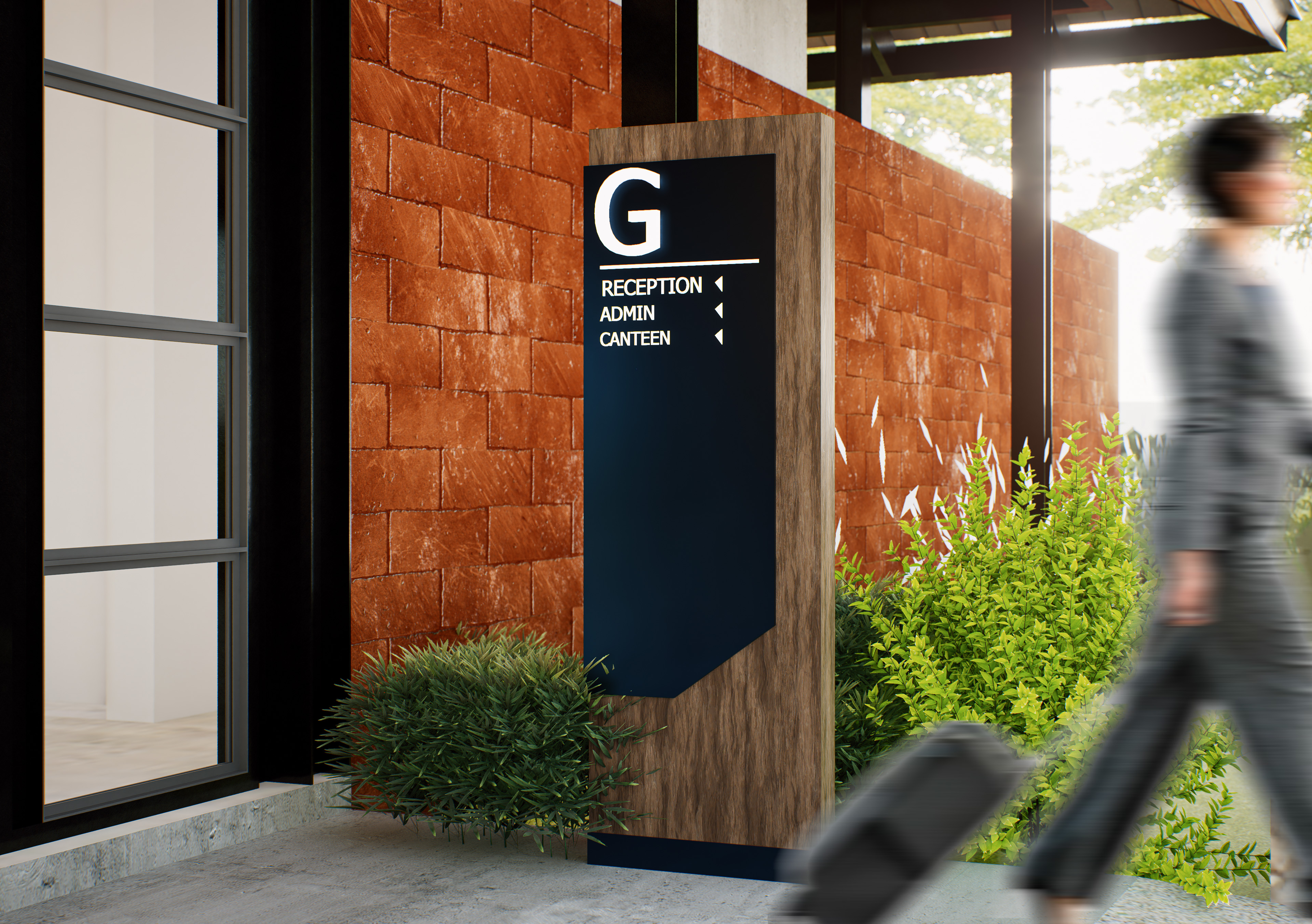 Black exterior gate wayfinding pylon beside landscaped entry