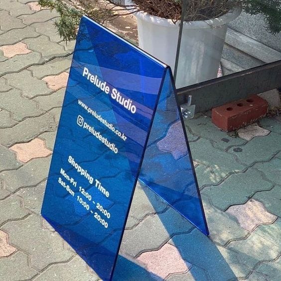 Blue A-frame sign for pharmacy parking directions