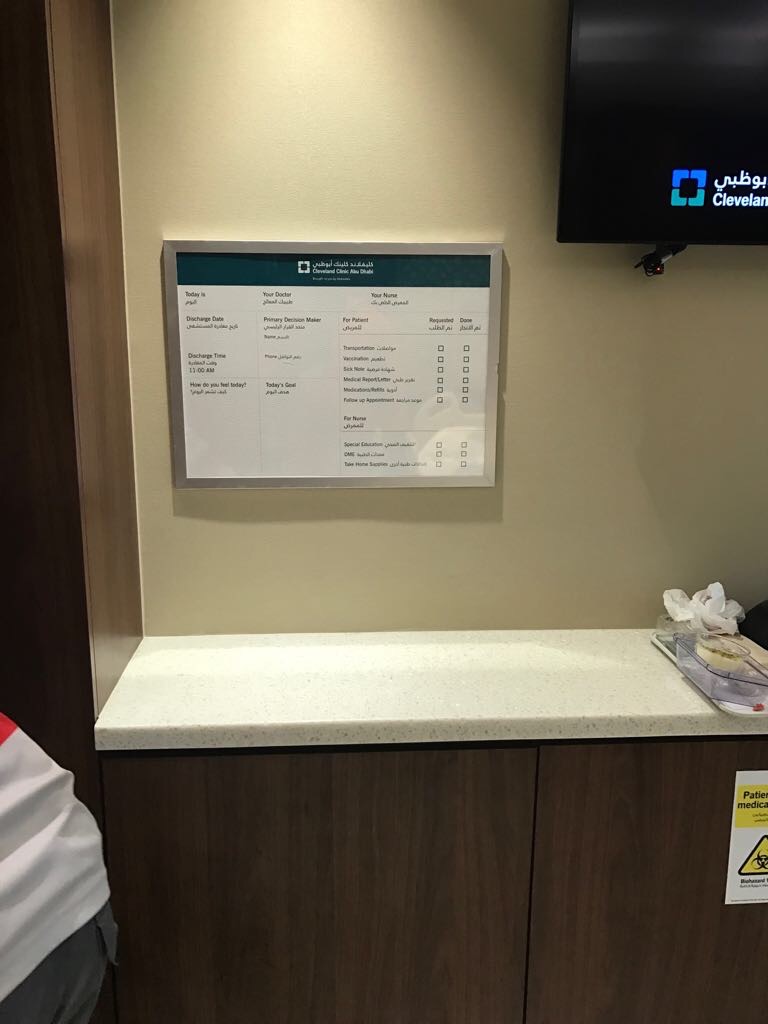 Clinic information wall plaque mounted in reception area