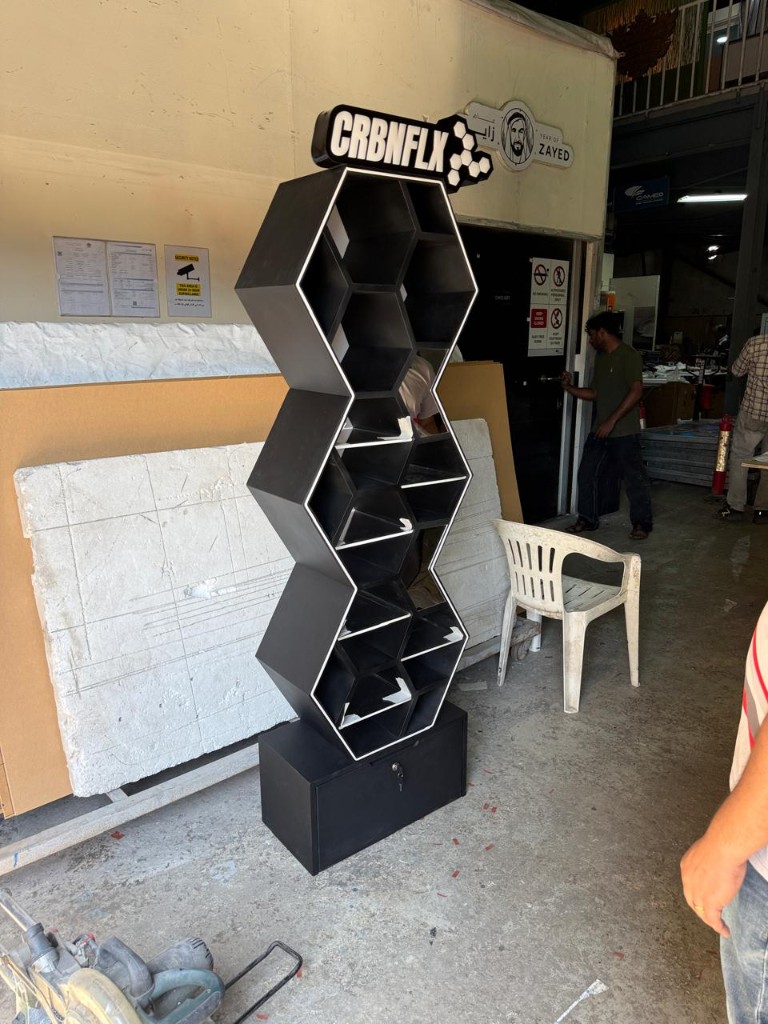 CRBNFLX honeycomb acrylic display stand with branded header