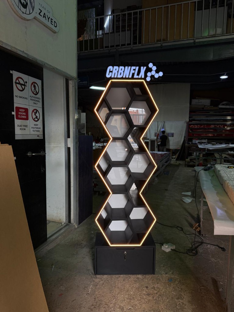 CRBNFLX honeycomb LED display stand illuminated in workshop
