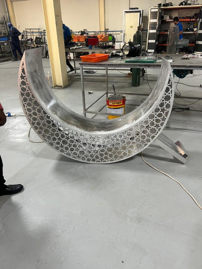 Large crescent moon sculpture during workshop fabrication