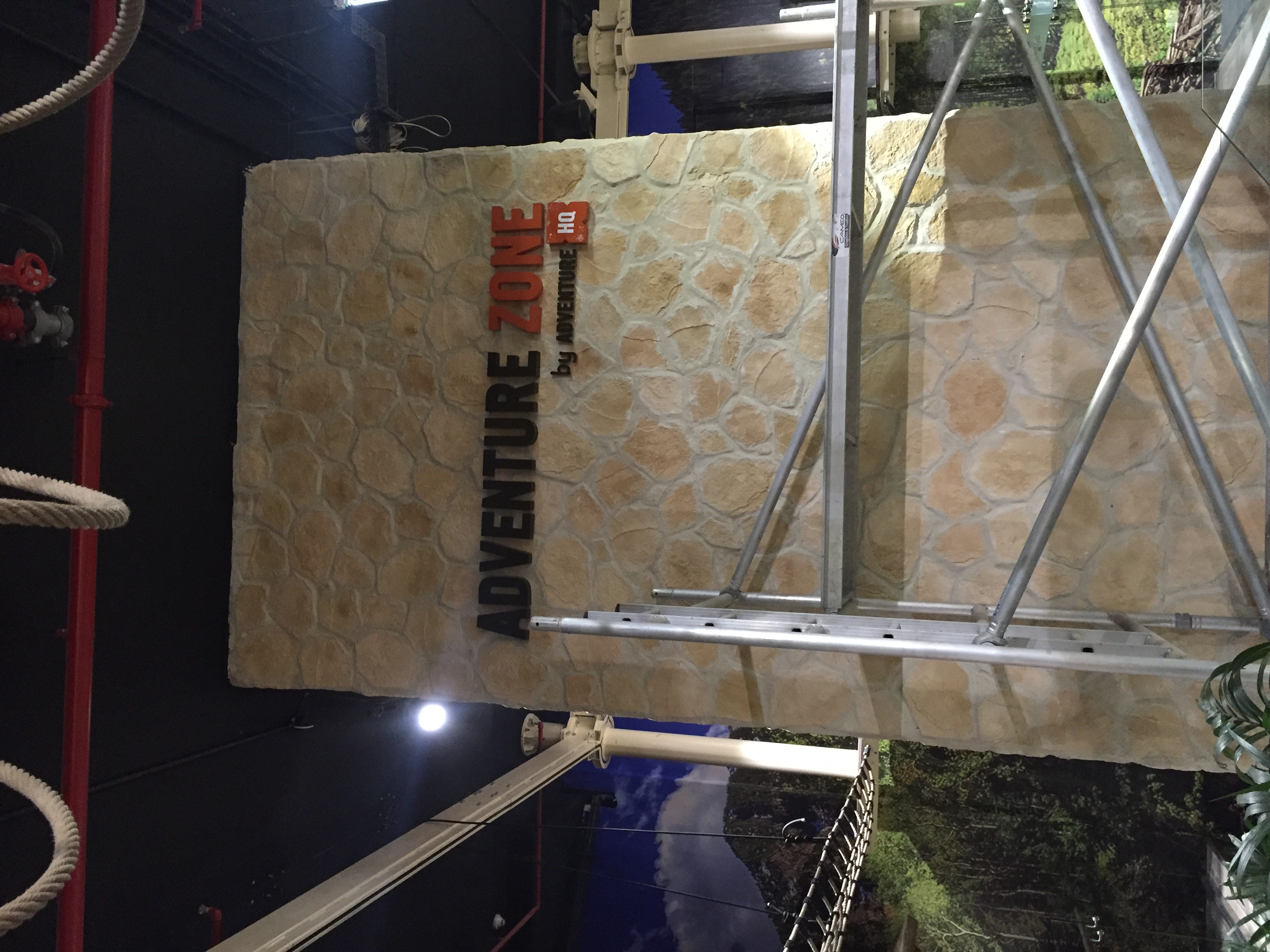 Exterior stone wall sign illuminated at night