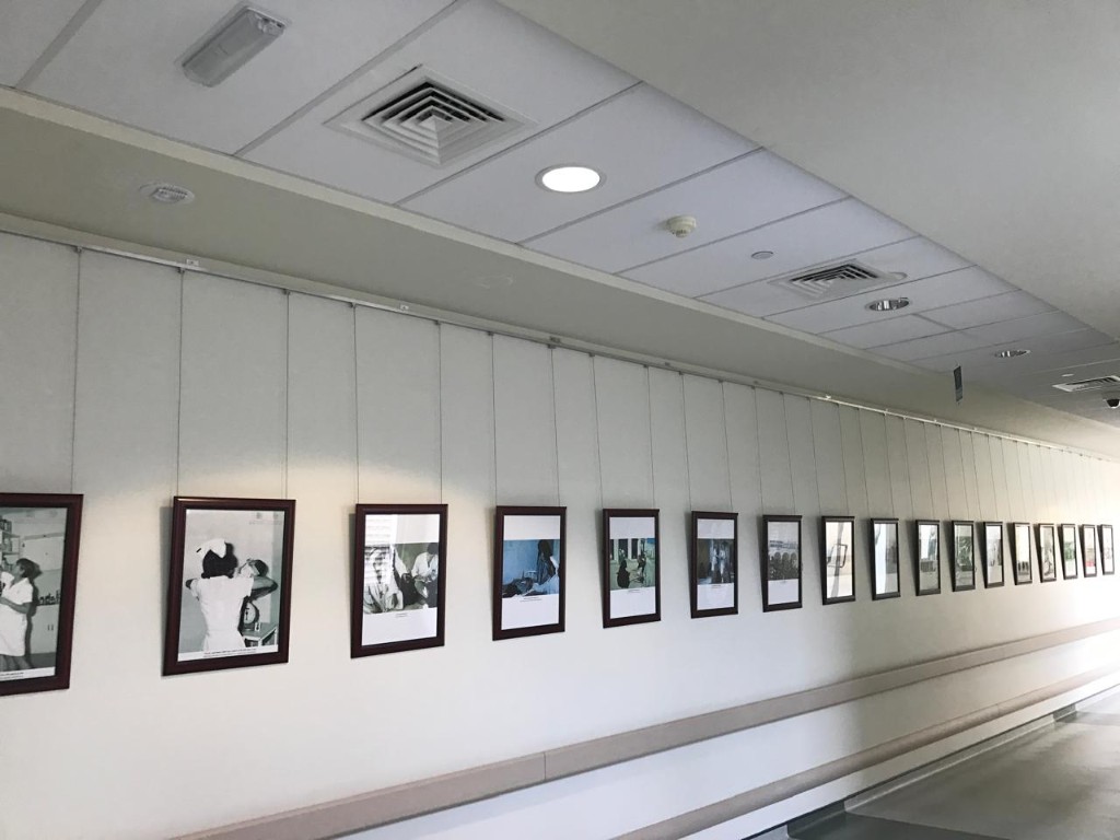 Hospital corridor photo gallery with cable-hung framed prints