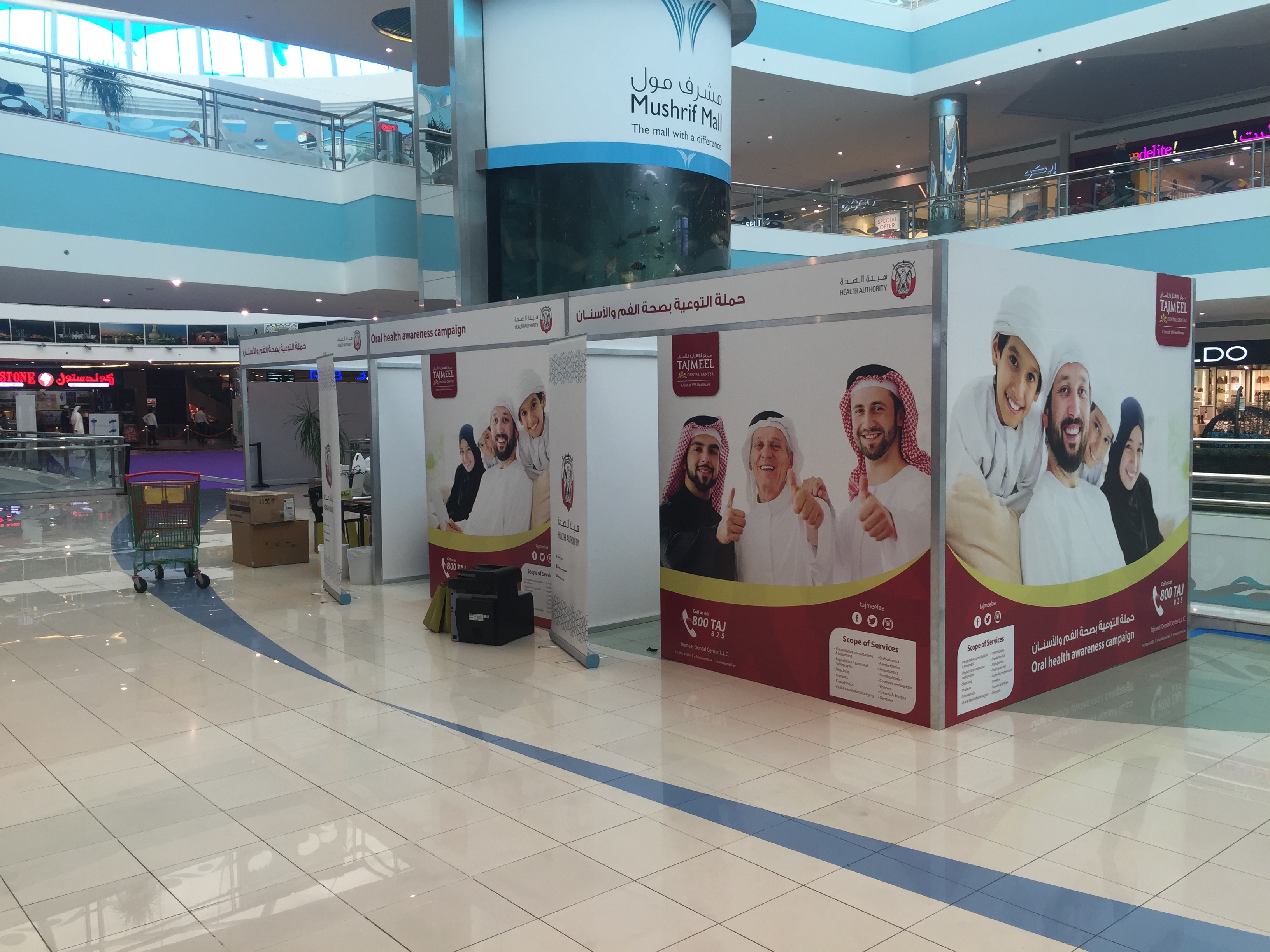 Mall atrium campaign booth with staffed counter