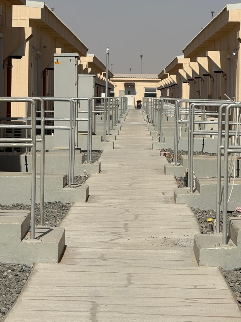 Modular housing camp with prefabricated units and site cranes