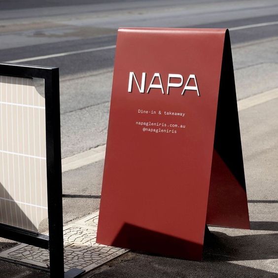 Red NAPA A-frame sign in covered parking area