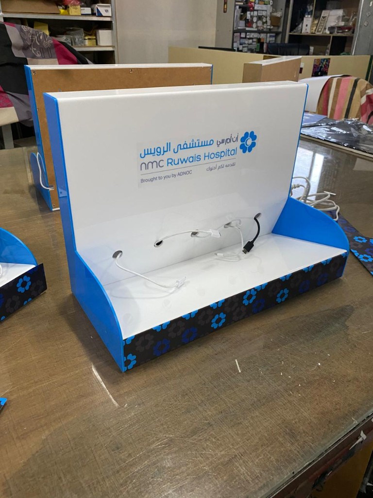 NMC Ruwais Hospital branded acrylic phone charging station