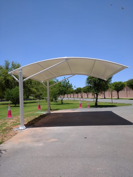 Outdoor fabric shade canopy over paved park area