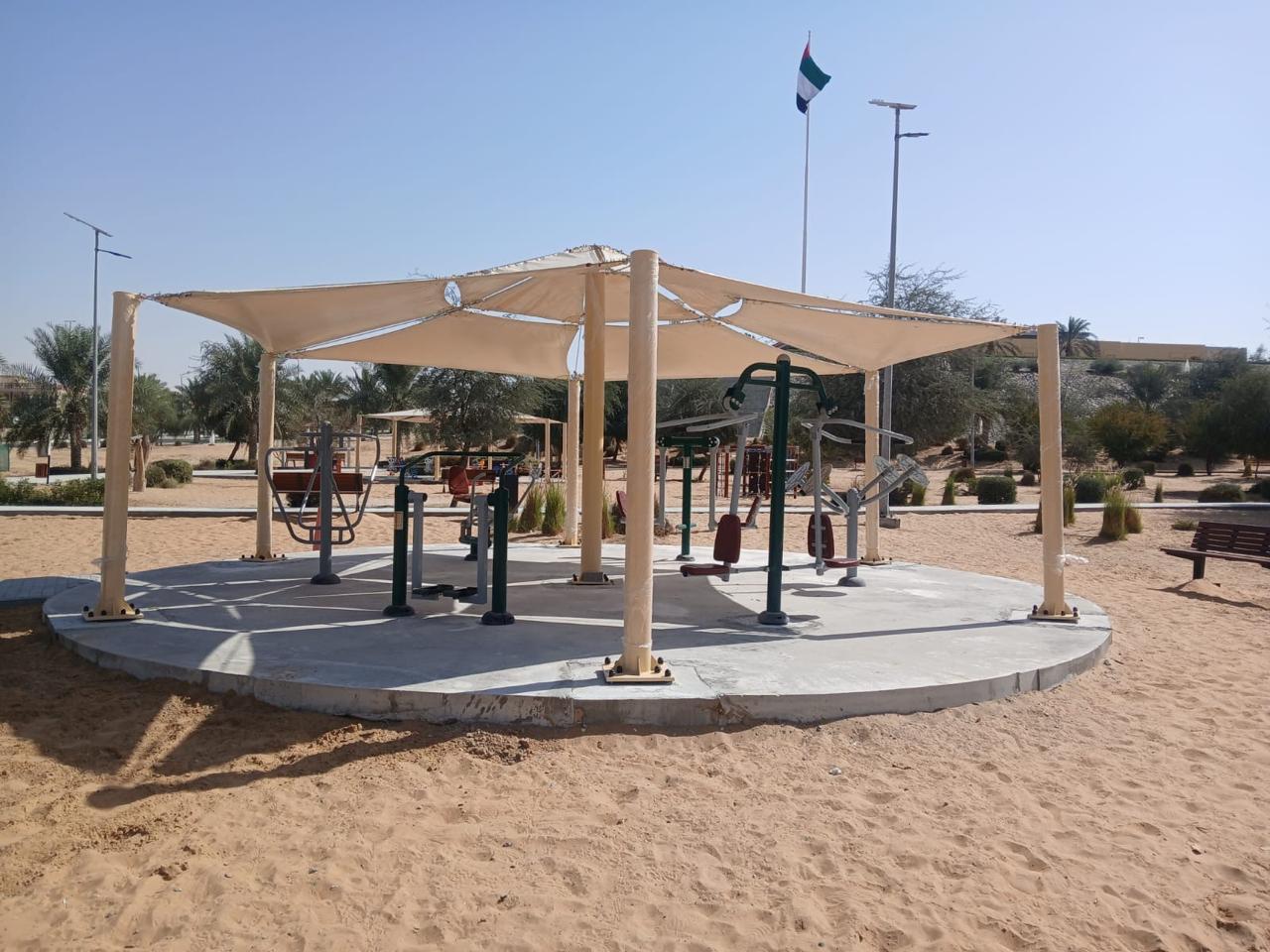 Park shade structure installation over circular seating area