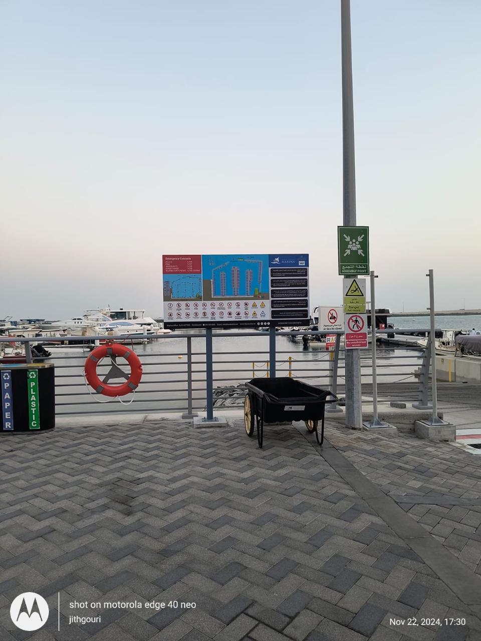 Outdoor parking directional post signs beside walkway