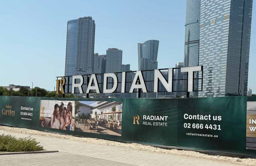 Radiant development hoarding signage beside high-rise towers