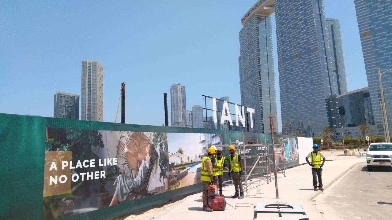 Team installing Radiant development hoarding graphics