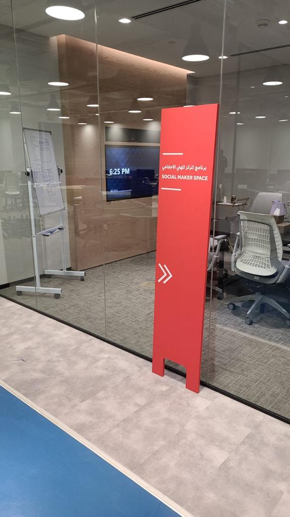 Red standing wayfinding totem in corridor