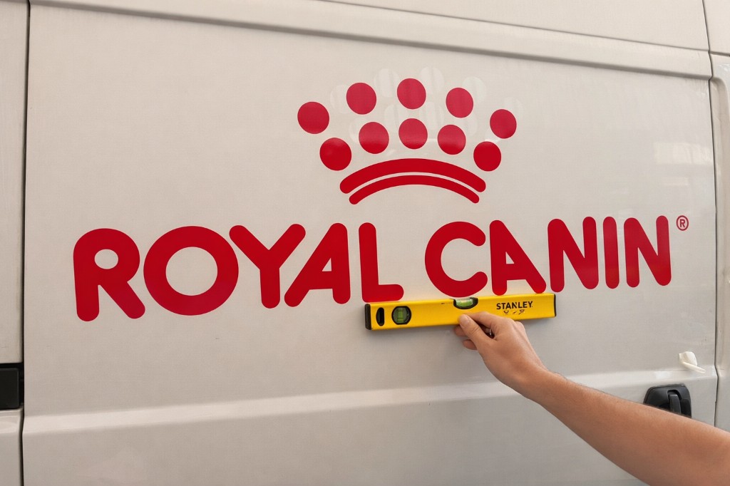 Royal Canin logo being installed on a delivery van