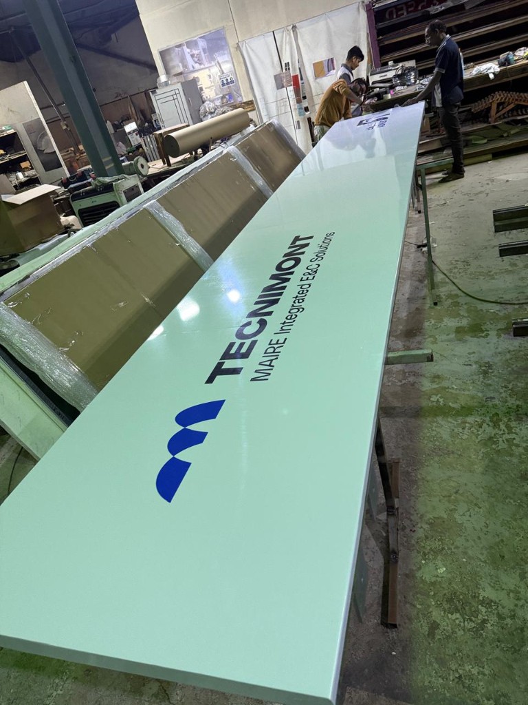 Tecnimont industrial project sign panel in fabrication shop