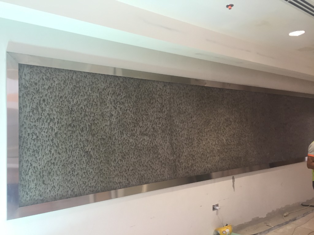 Custom textured architectural wall panel during site installation