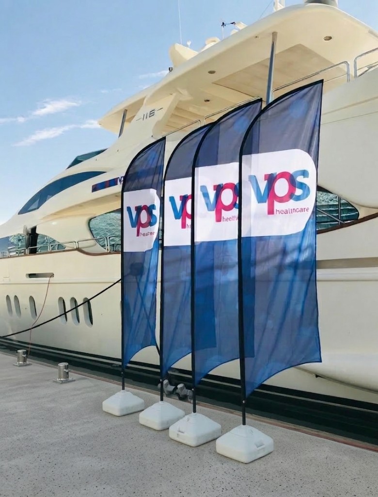 VPS Healthcare branded feather flags on a marina dock