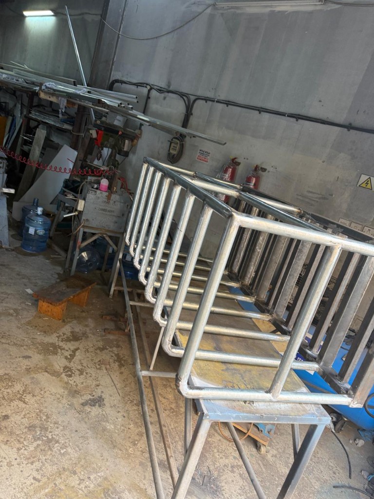 Welded metal frame rack on workbench in fabrication shop
